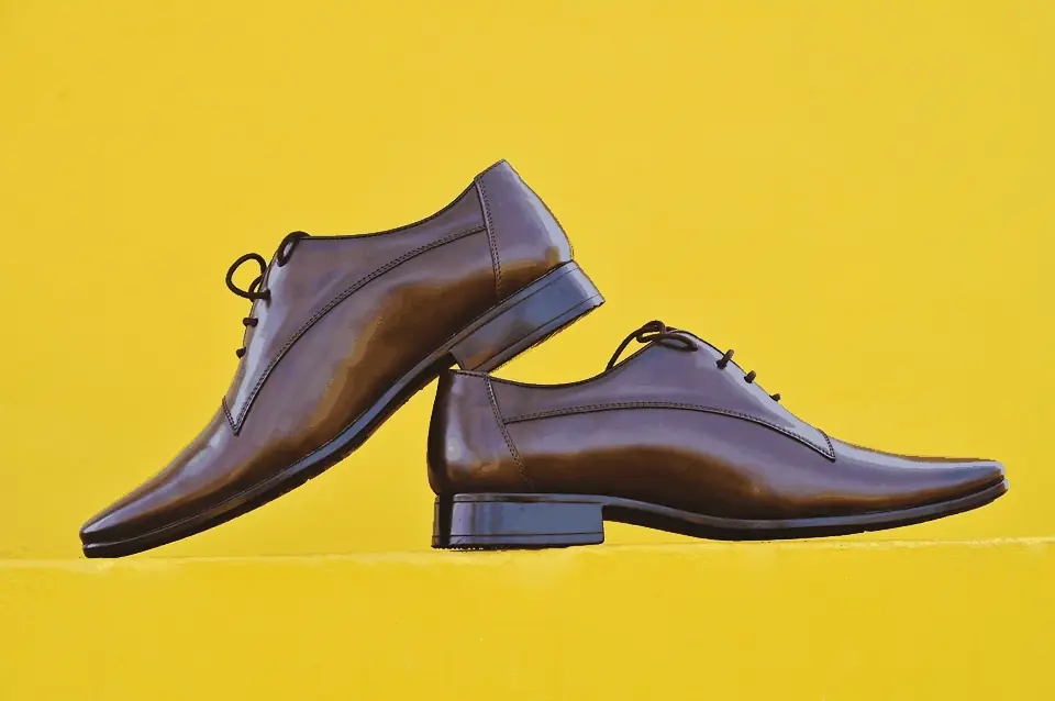 A photo of a pair of leather shoes with the yellow background cut away, leaving the shoes on transparency